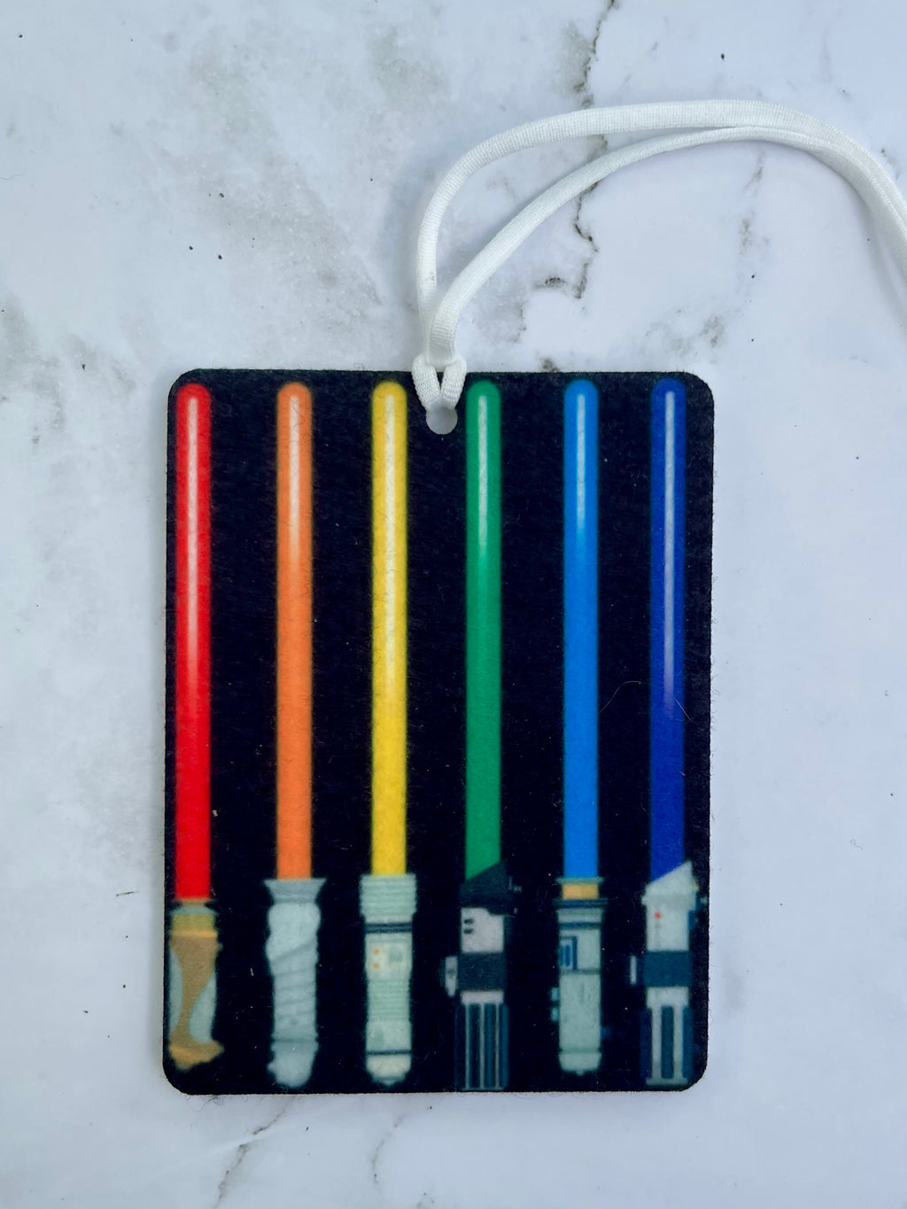 Laser sword design on a black background with colorful lightsabers, hanging against a marble surface.