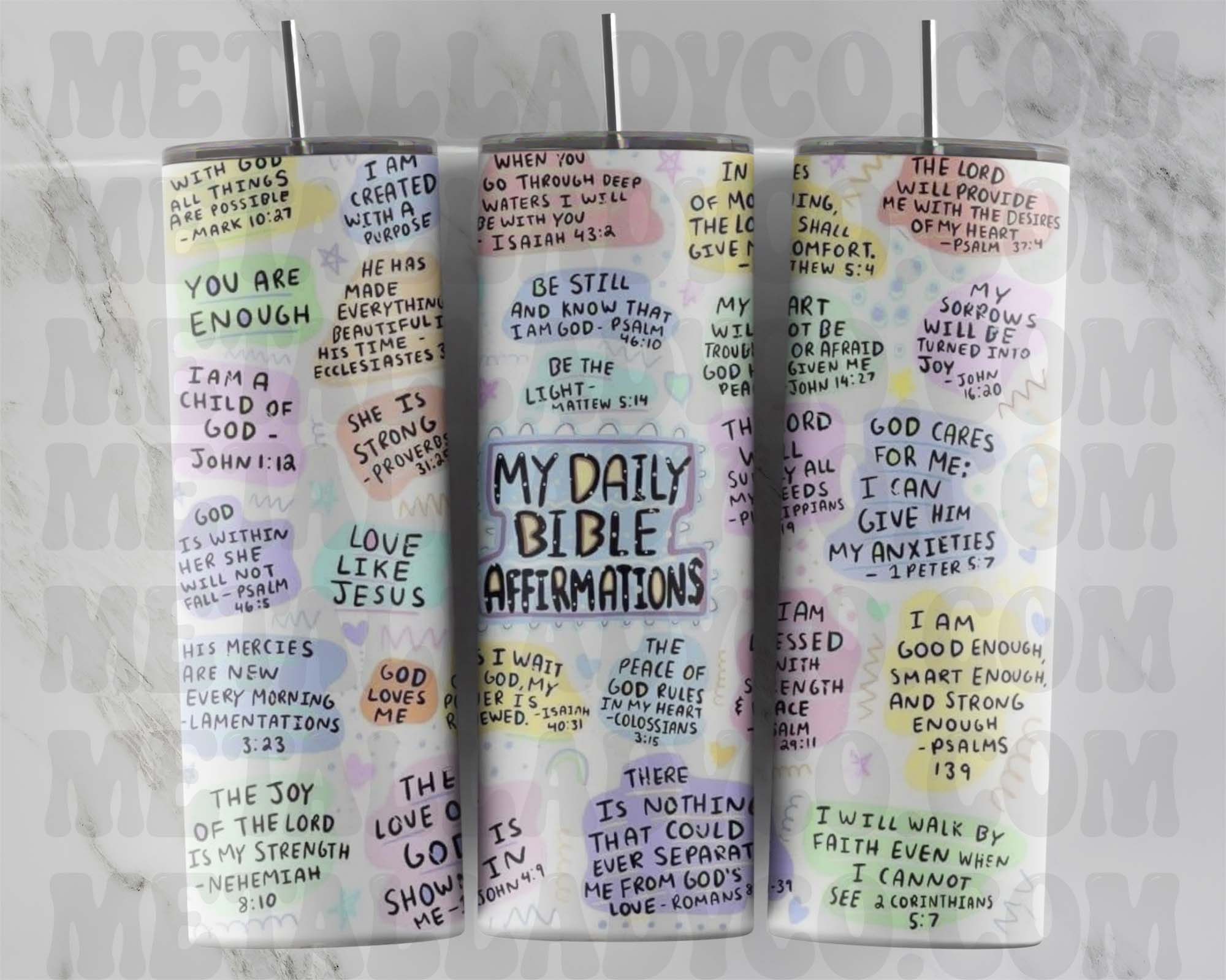 Two tumblers with colorful daily Bible verses affirmations written on them, one with a clear lid and straw, the other without.